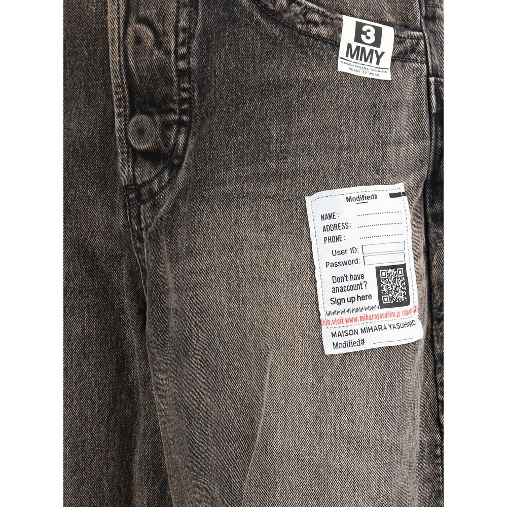 Pair of blue jeans with a white tag on the left leg