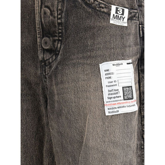 Pair of blue jeans with a white tag on the left leg