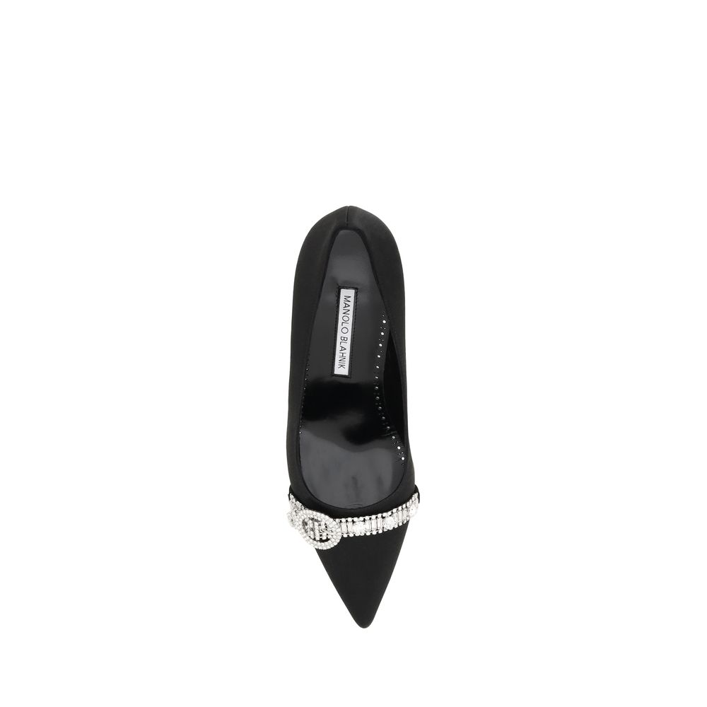 Black shoe with a pointed toe and embellishments on the heel
