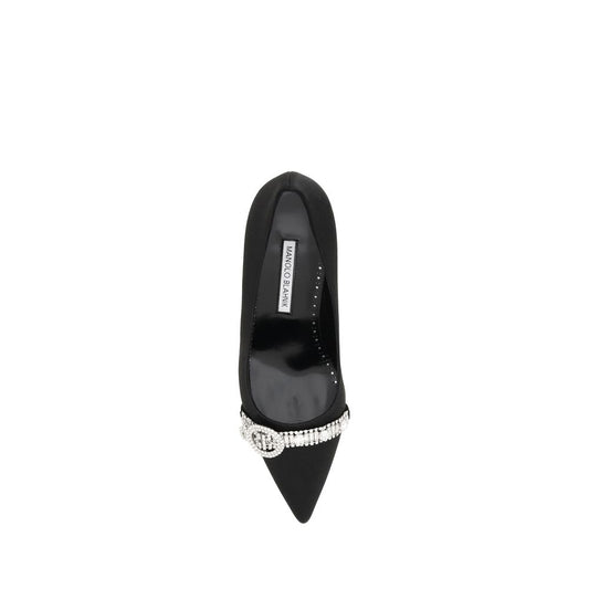 Black shoe with a pointed toe and embellishments on the heel