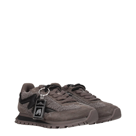 A pair of gray fur chunky sneakers with a black tag on the tongue