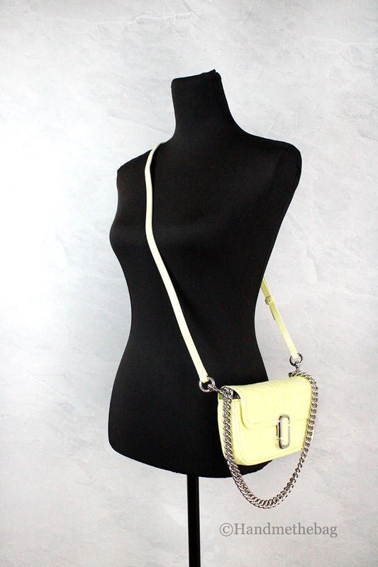 Yellow crossbody bag on black mannequin