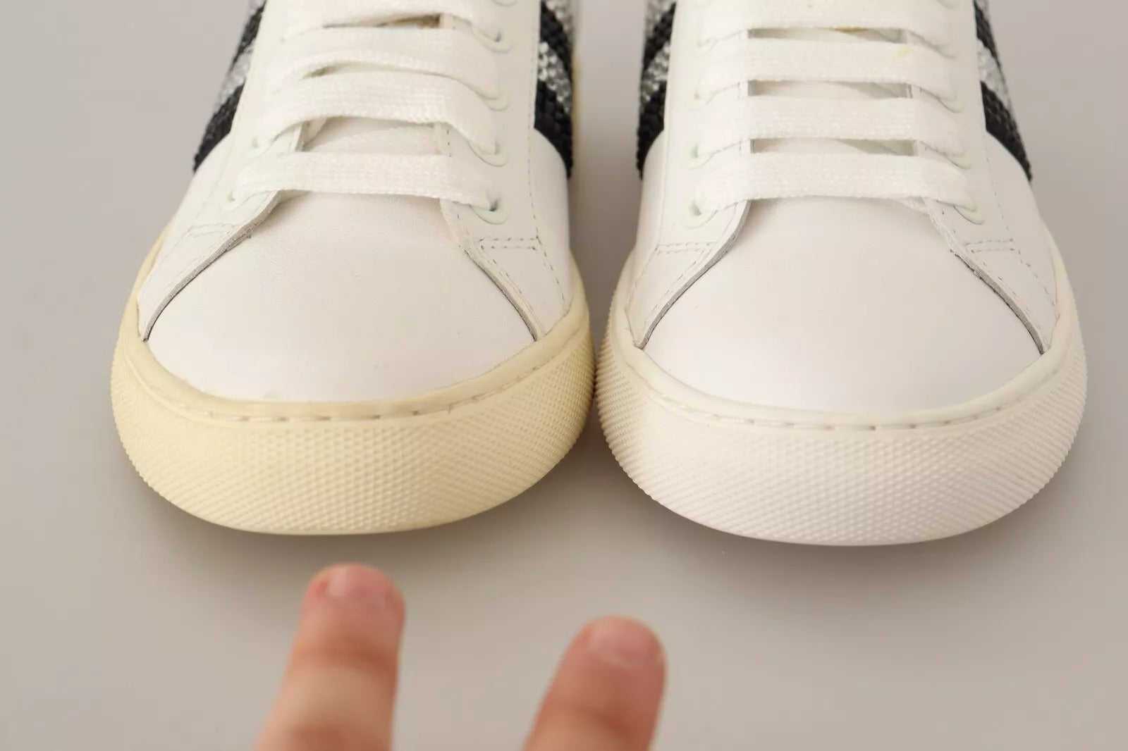 Pair of white sneakers with black laces