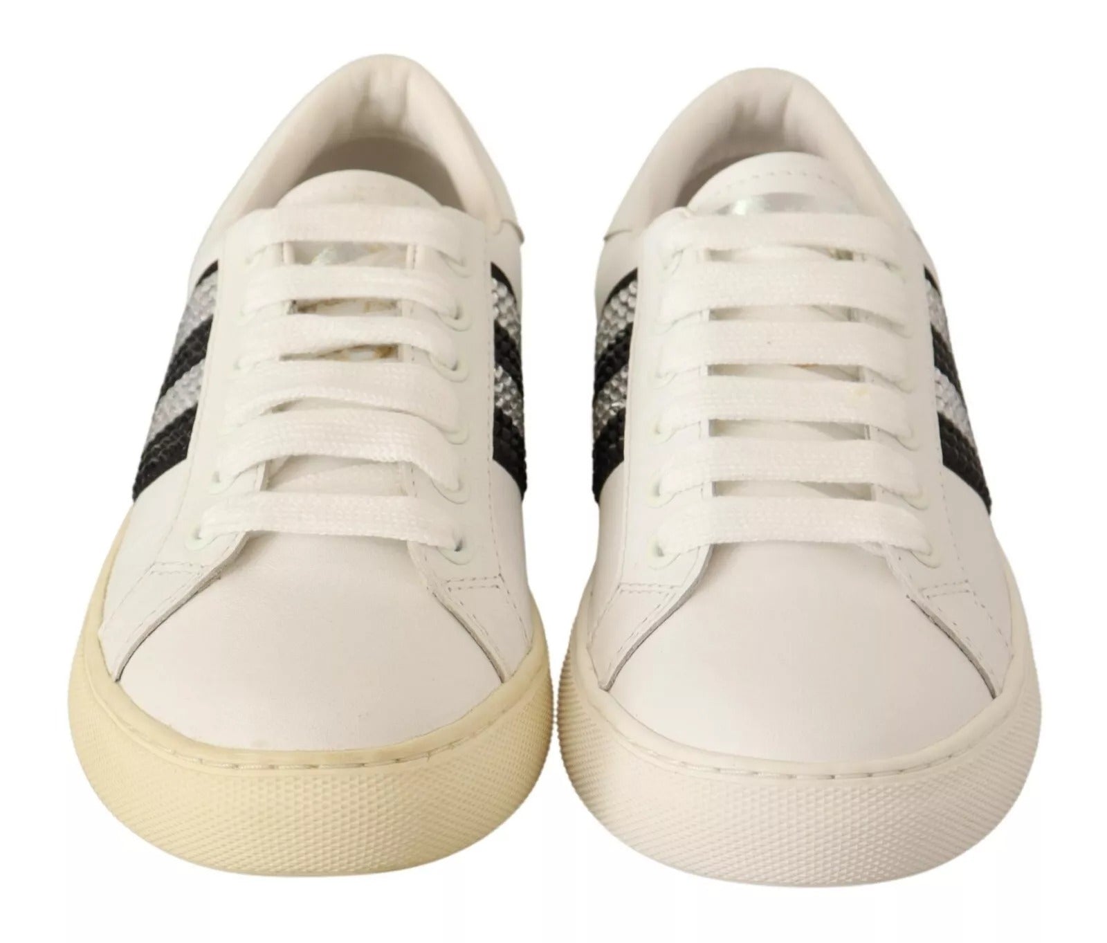 Pair of white sneakers with black stripes on sides