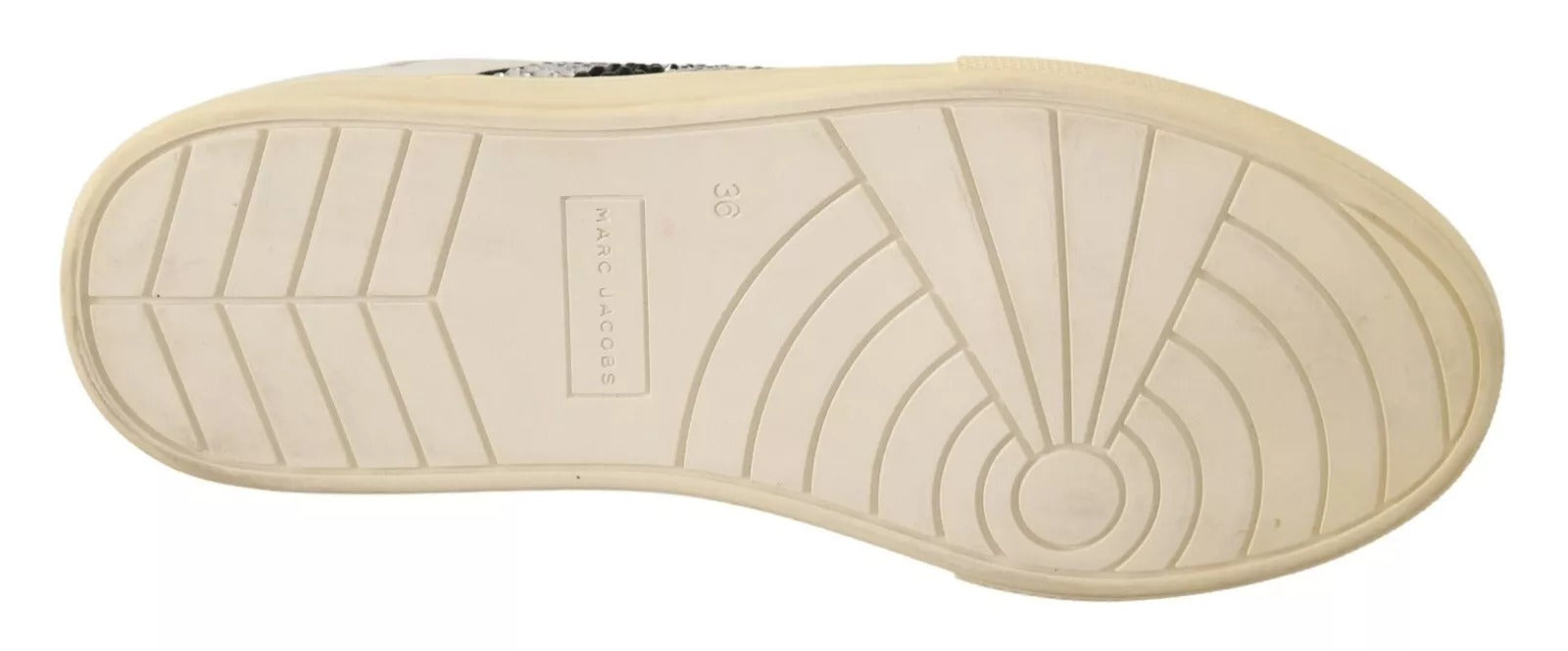 Pair of tan sneakers with white soles