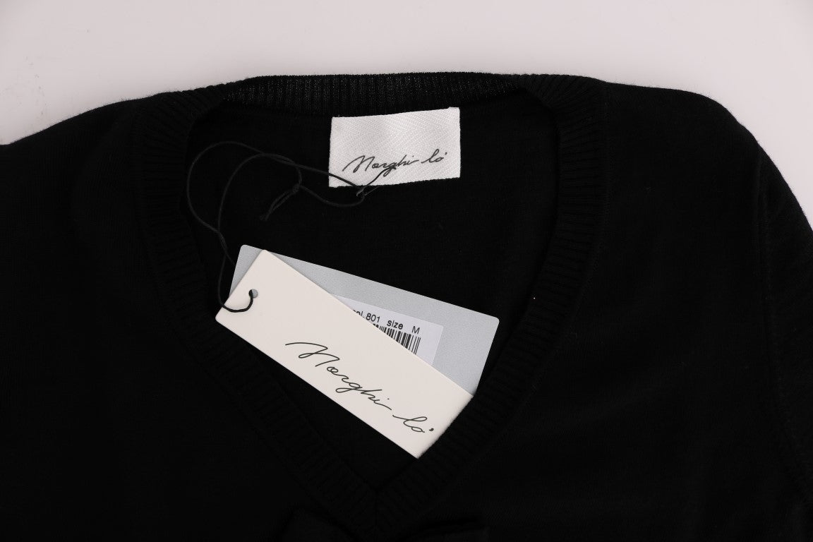 Black sweater on hanger with tags attached to collar