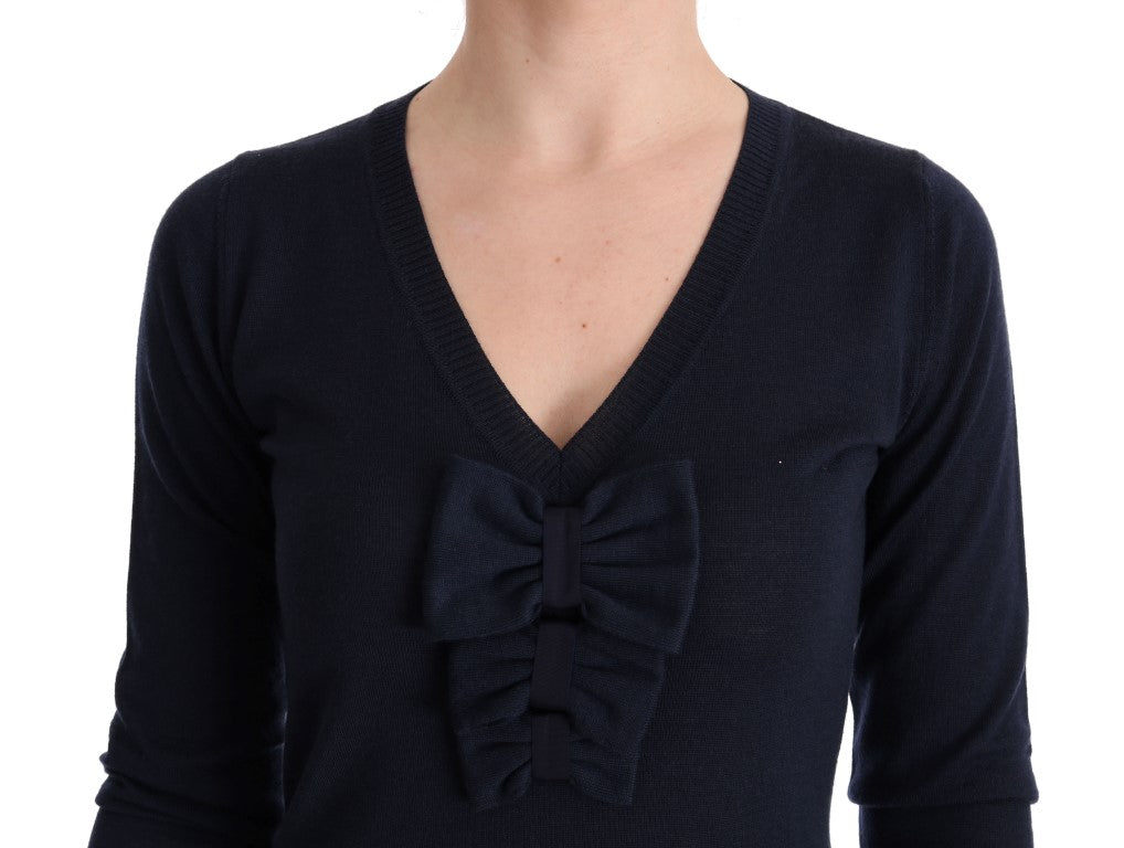 Navy blue sweater with bow tie detail on front