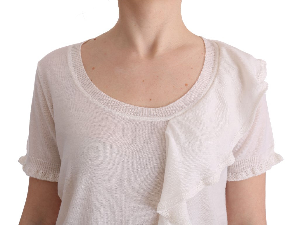 Woman wearing a white long sleeve shirt with ruffled cuffs