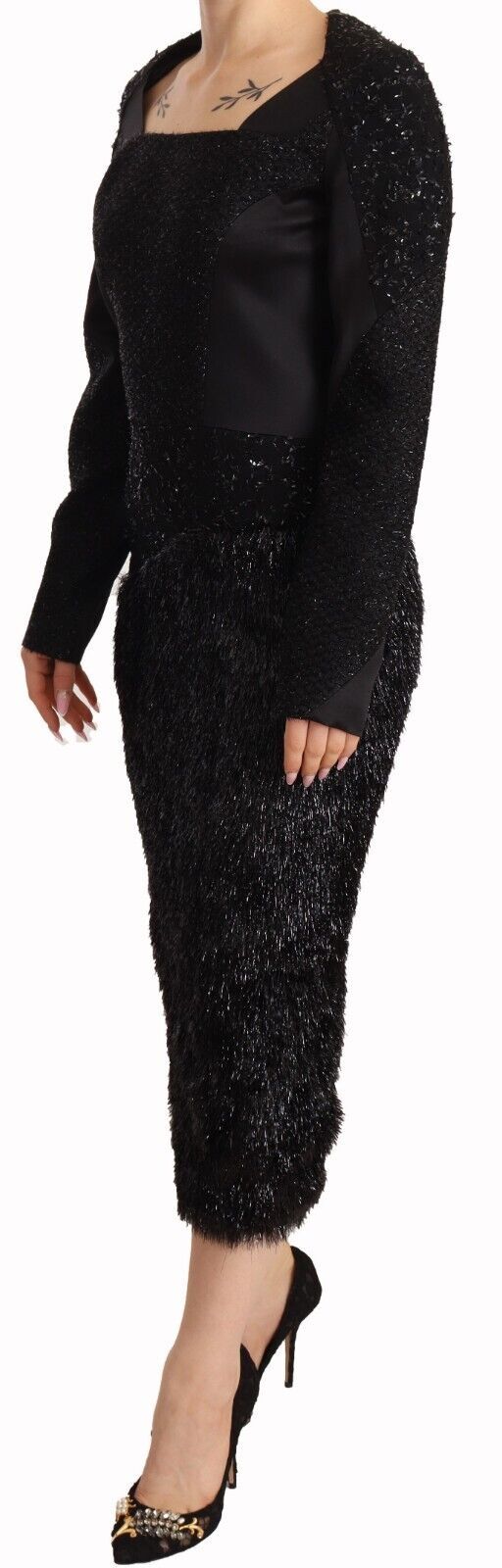 A black long sleeve sheath dress with studded embellishments