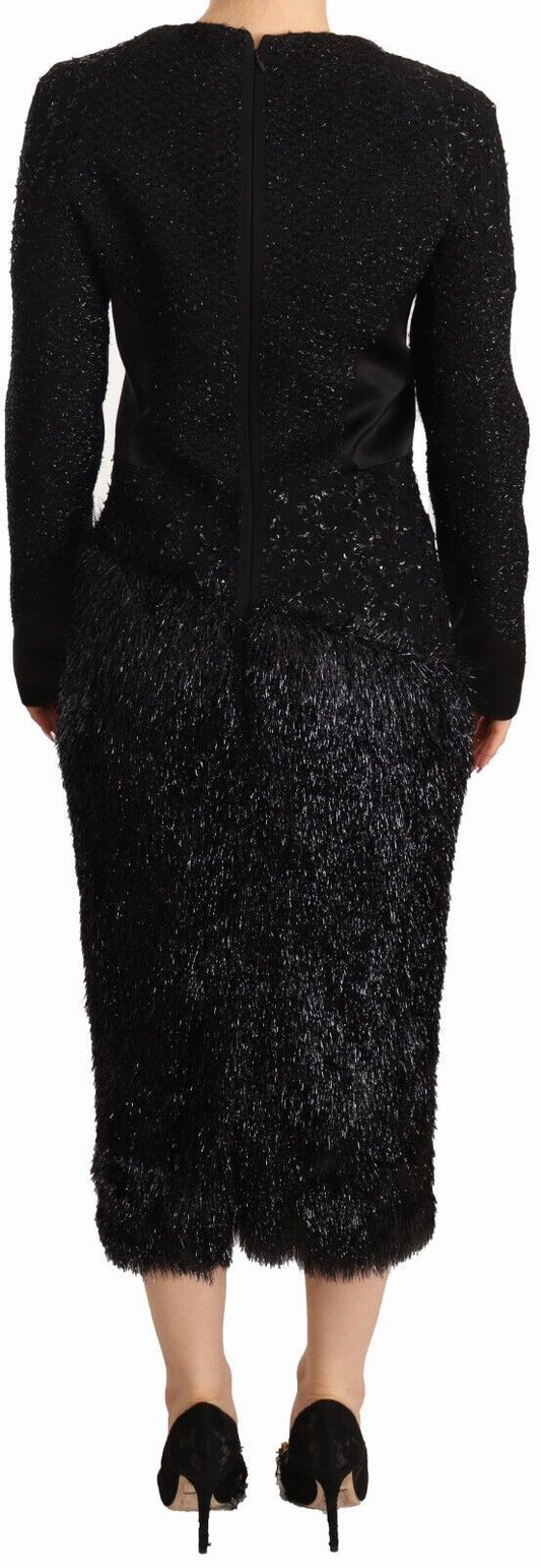 A black dress with long sleeves, embellished with studs and featuring a sheath silhouette