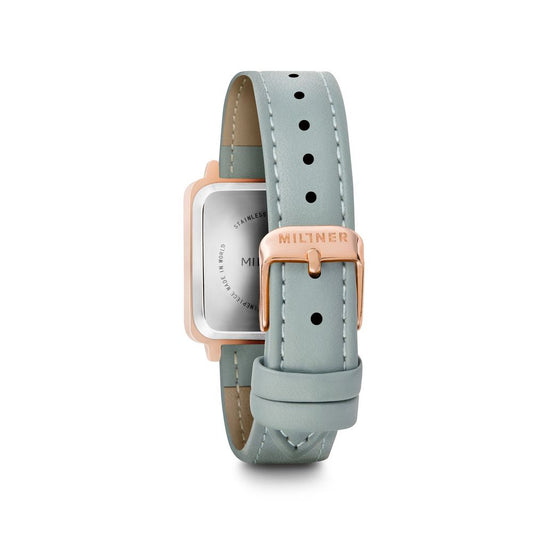 A blue leather watch with a pink face and silver accents, featuring the brand name "Millner" on the strap and face
