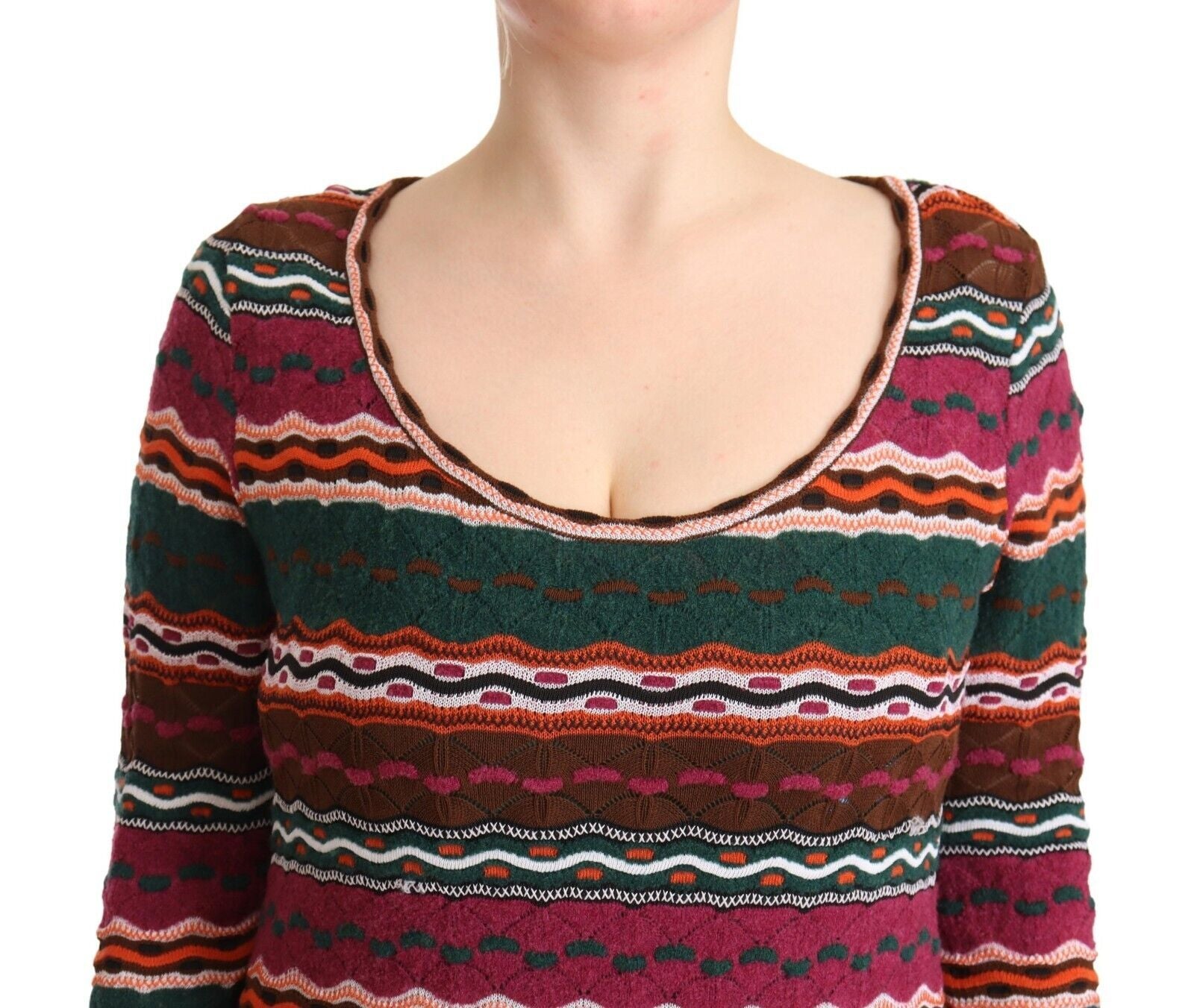 A woman wearing a multicolored striped knit dress with long sleeves