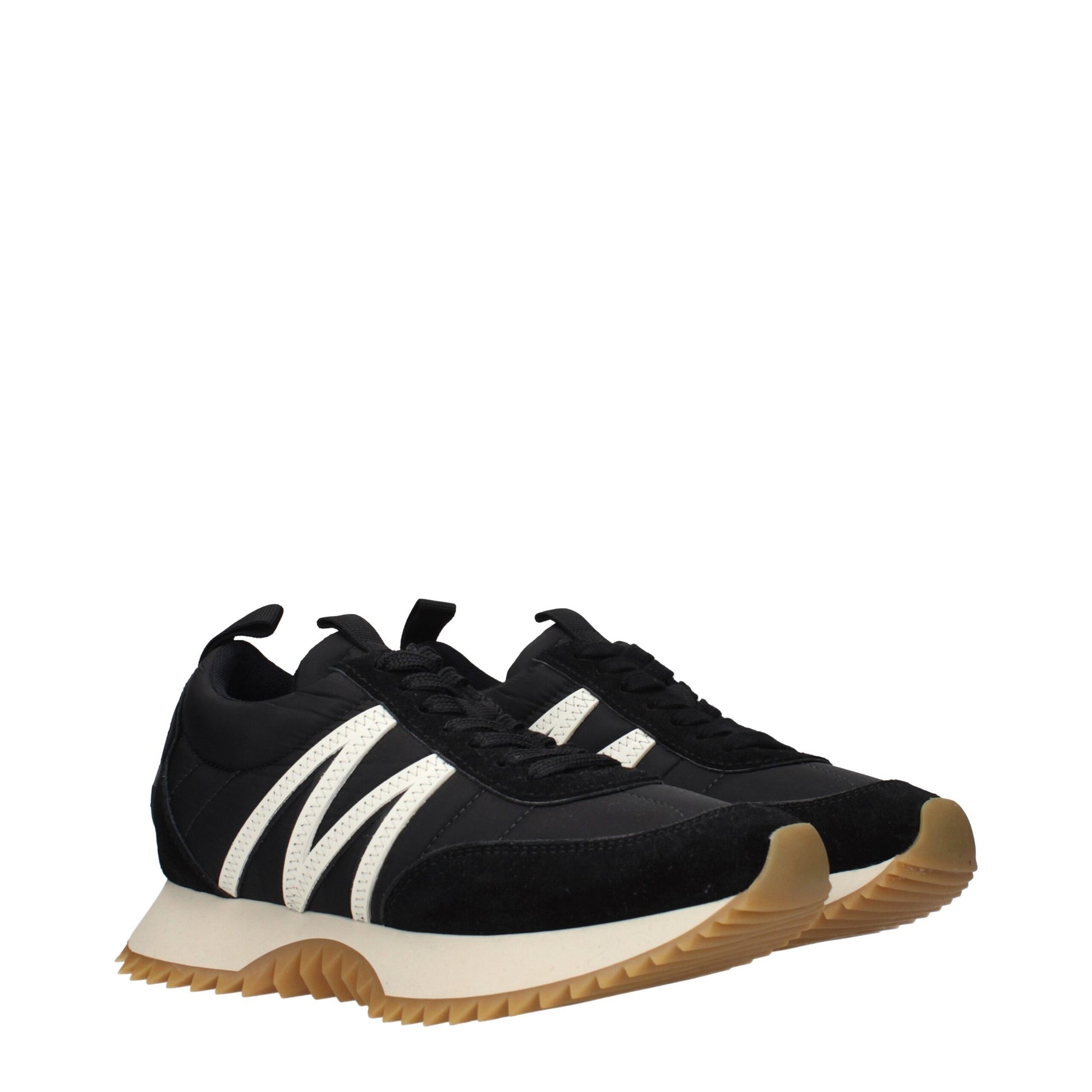 A pair of black sneakers with white stripes on the side, featuring a low top and a rubber sole