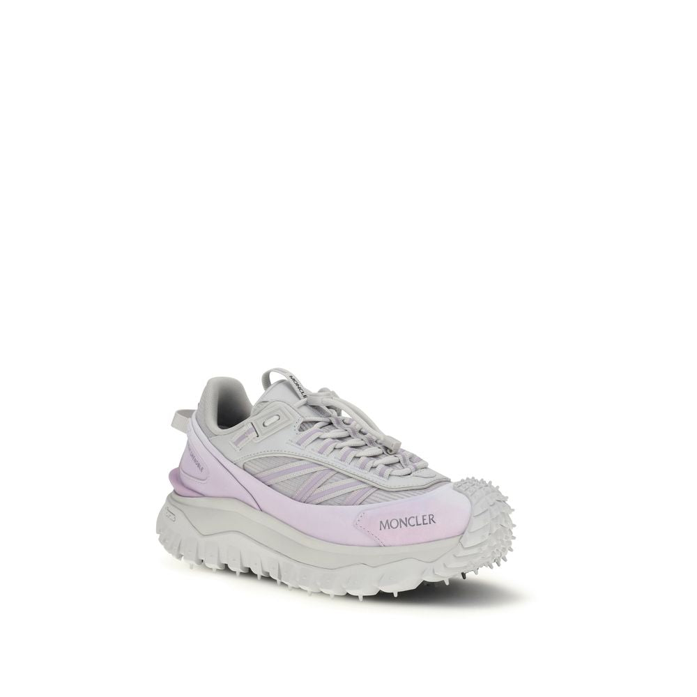 Pair of pink athletic sneakers with white sole, featuring brand name on side and textured bottom for traction
