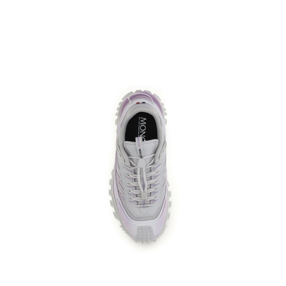 Pair of purple athletic sneakers with white laces, branded logo on side and sole