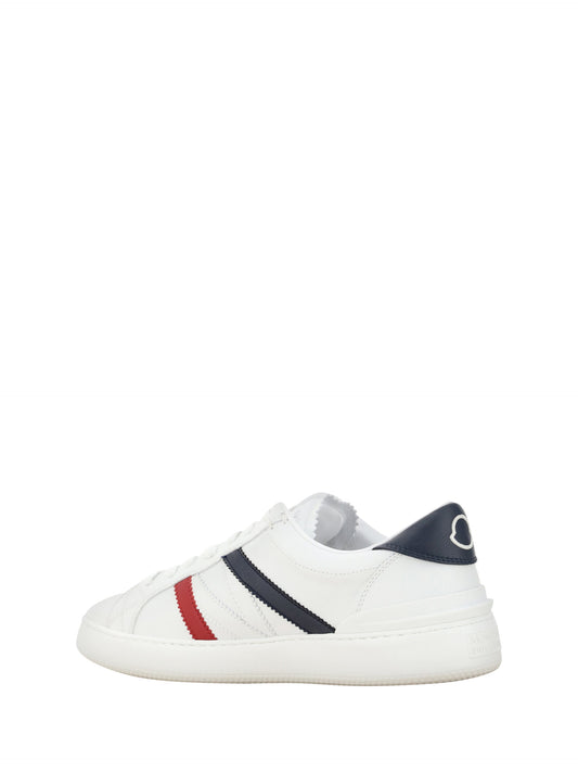 A pair of white sneakers with red stripes, featuring a low top design