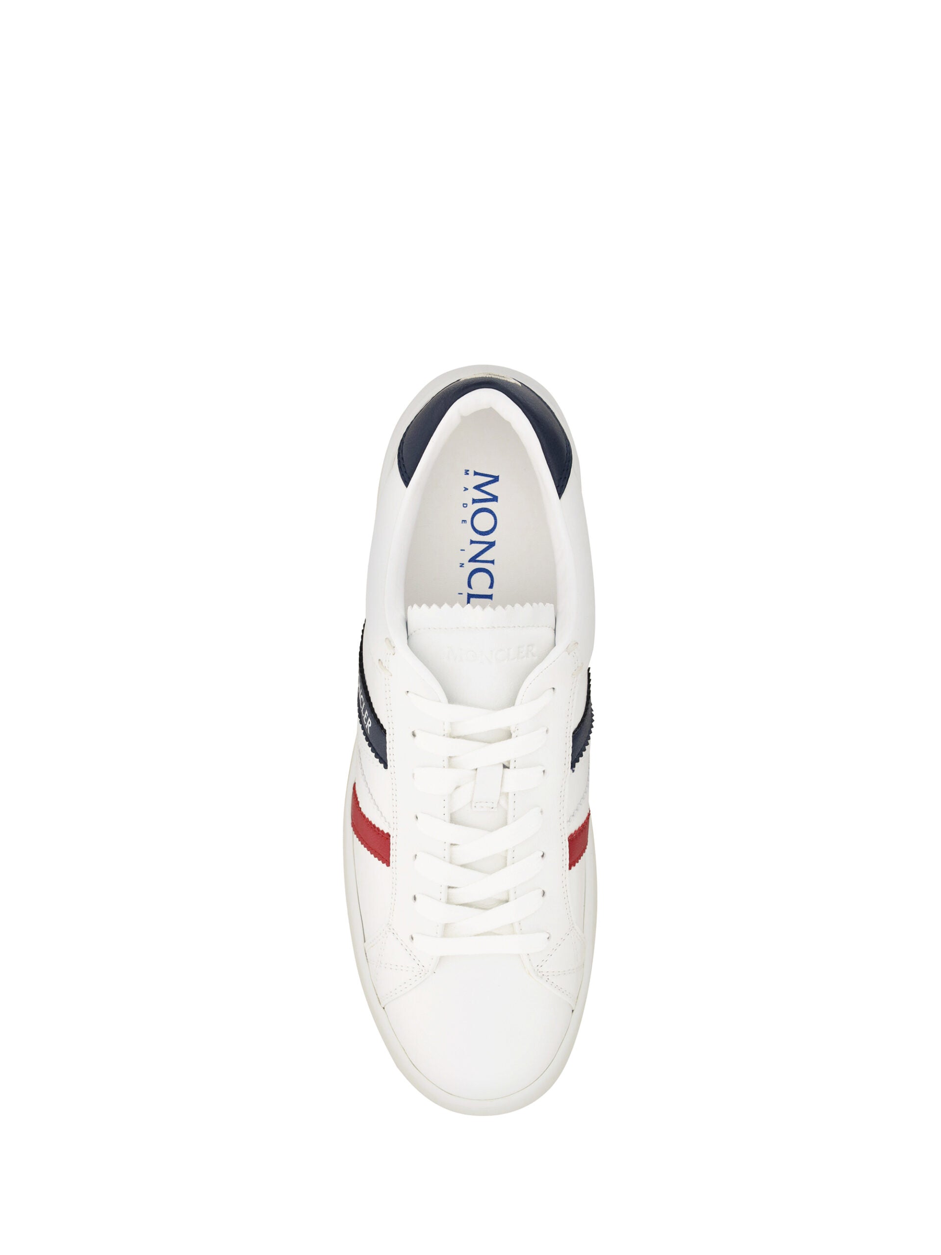 A pair of white sneakers with red accents, featuring a low top design