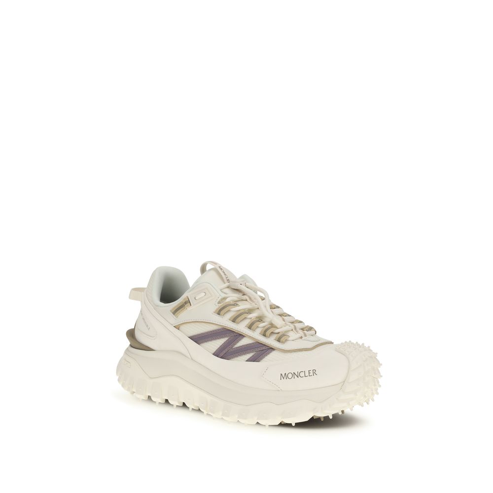 A pair of white athletic sneakers with a purple logo on the side, featuring a textured sole and laces