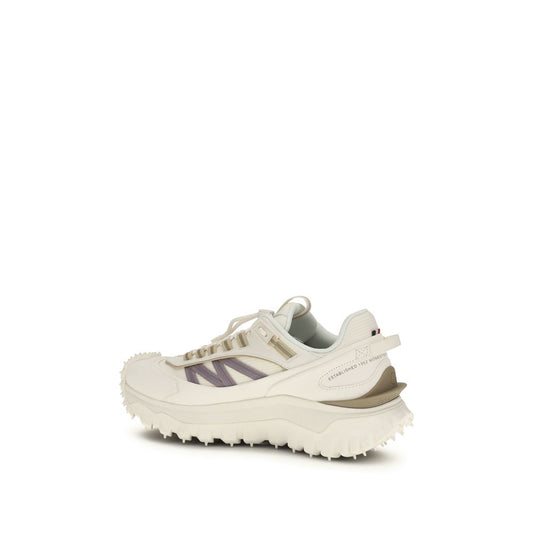 A pair of white athletic sneakers with purple accents, featuring a textured sole and laces