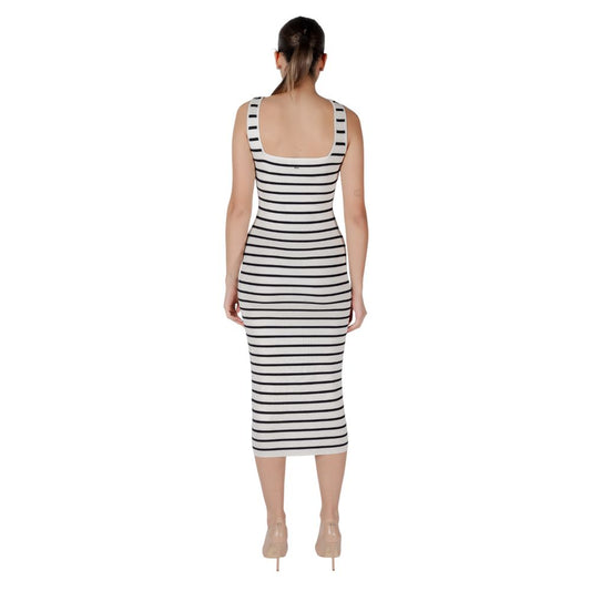 A woman wearing a black and white striped dress with short sleeves