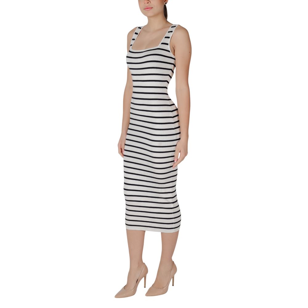 A woman wearing a black and white striped dress with short sleeves