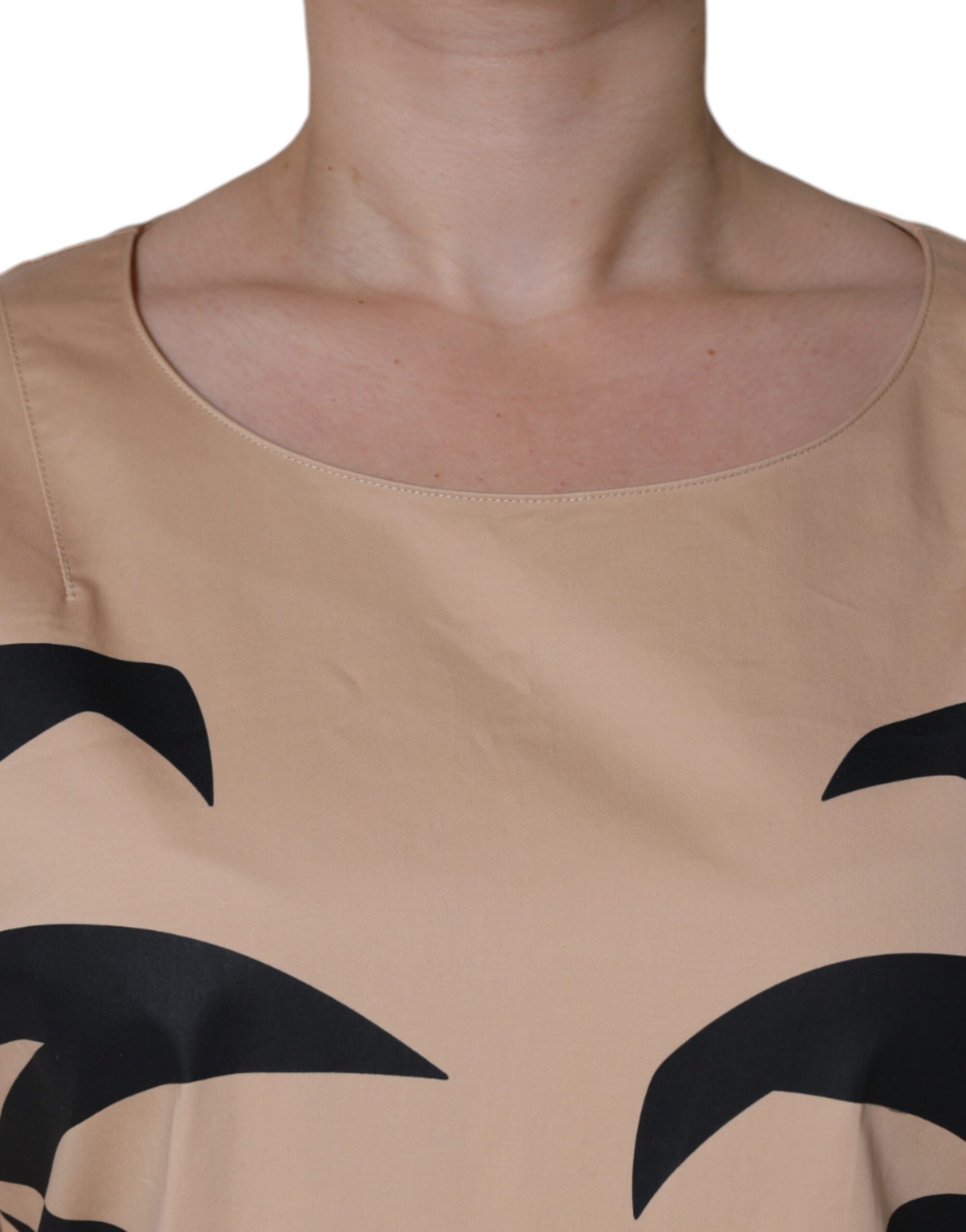 Woman wearing a sleeveless dress with black pattern on bodice