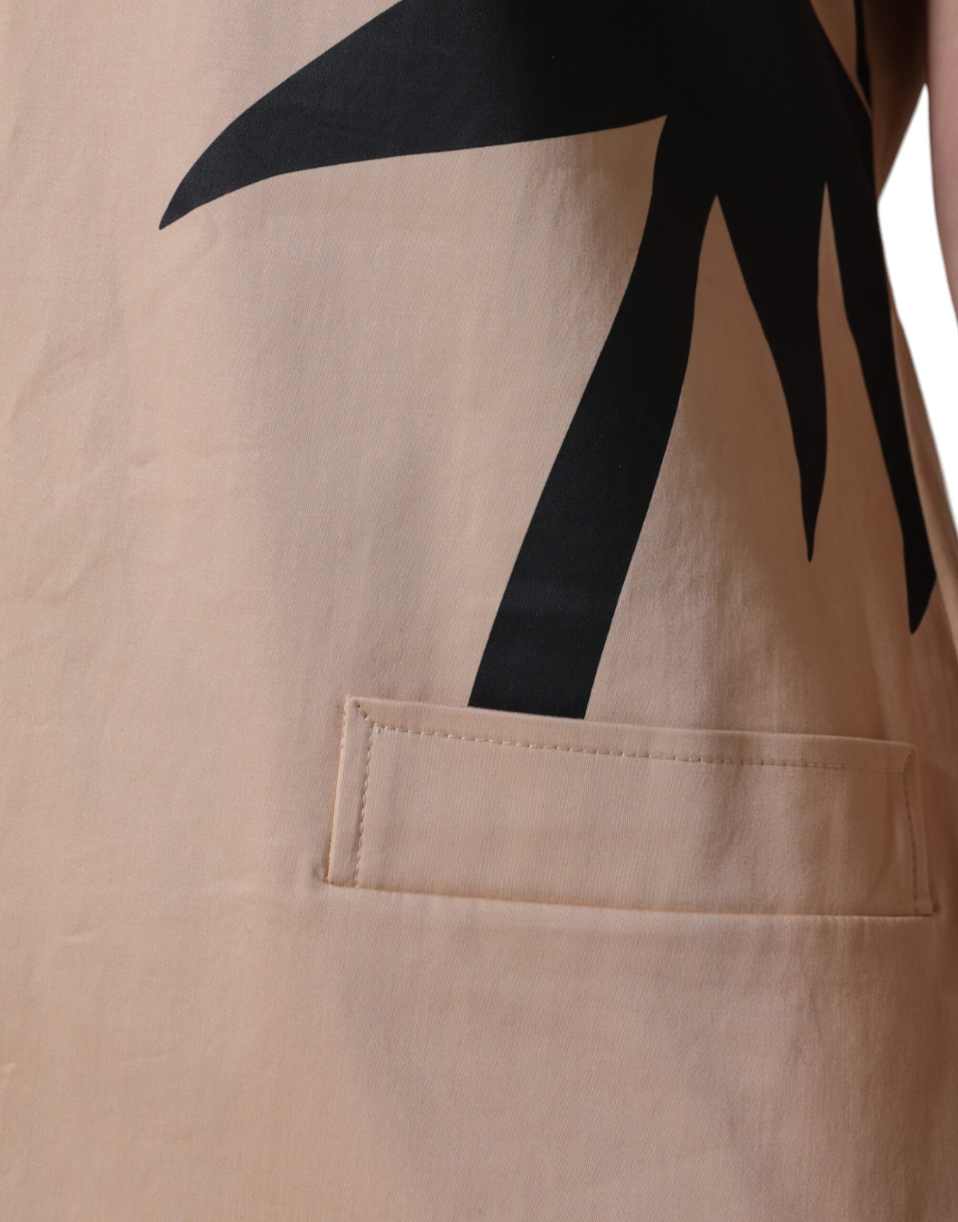 Tan cargo pants with black logo on left leg