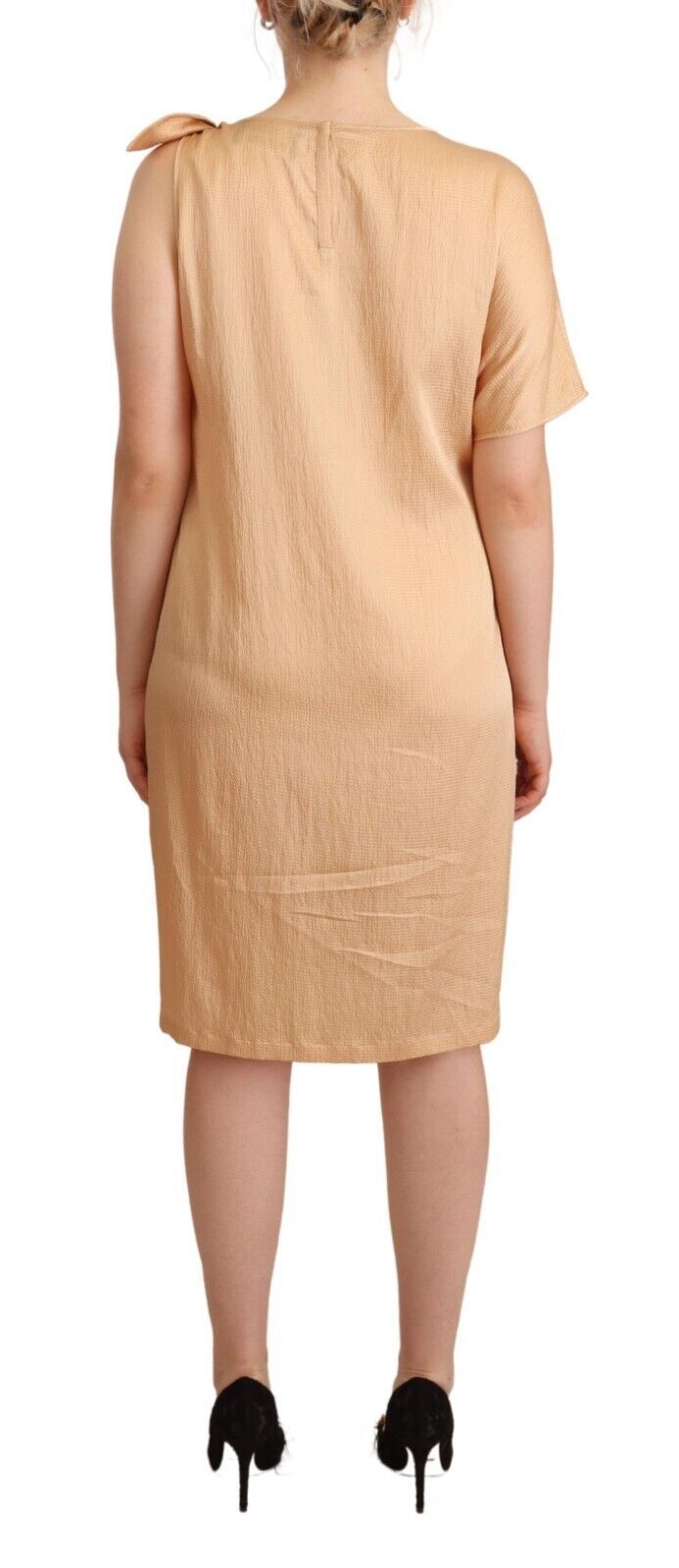 A beige knee length shift dress with one sleeve, designed by Moschino