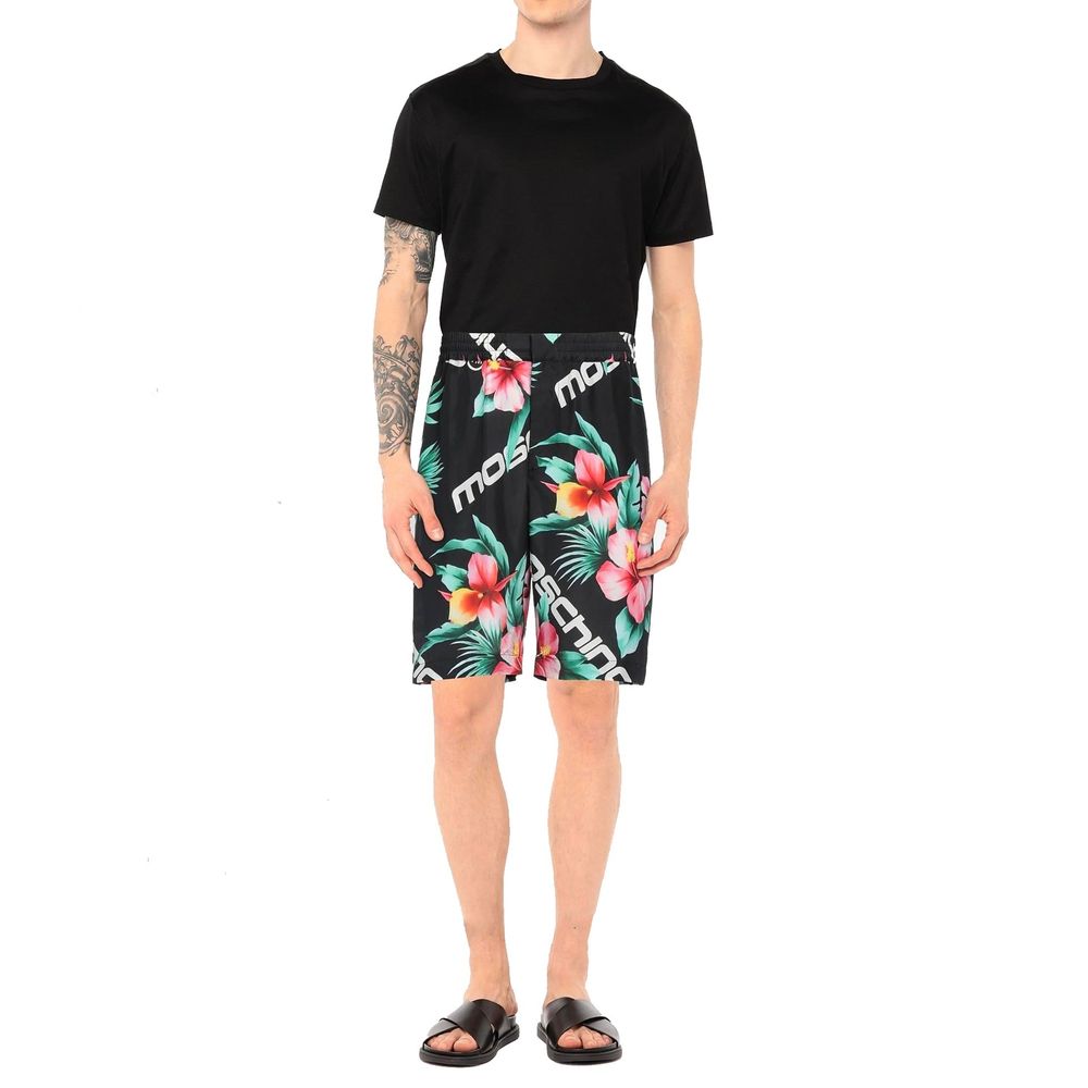 Man wearing black t-shirt and floral print shorts