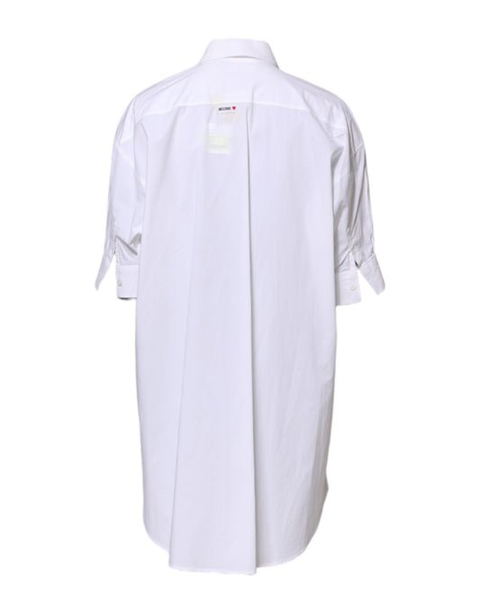 A white collared button mini shirt dress with a printed design