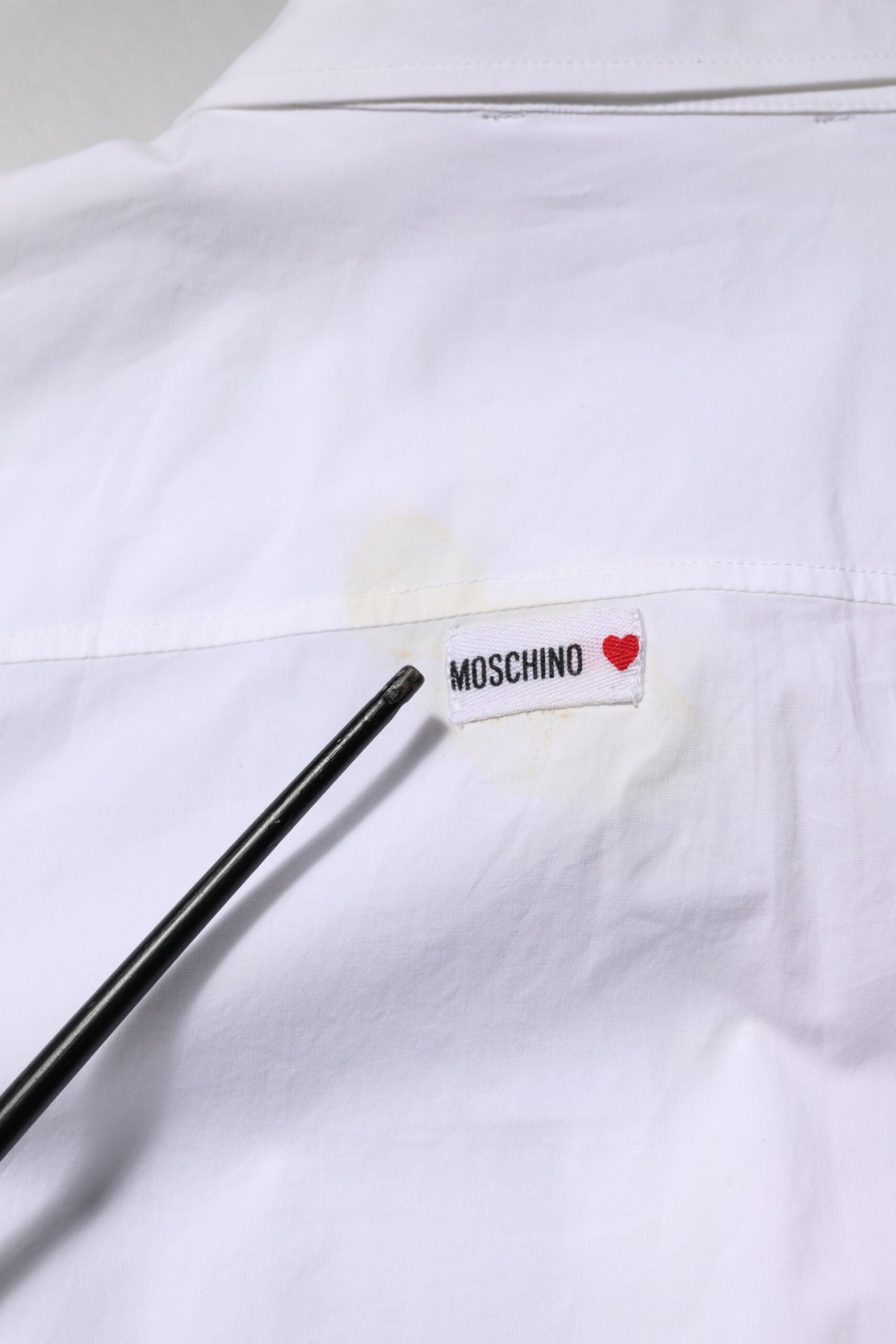 A white printed collared button mini shirt dress by Moschino Couture