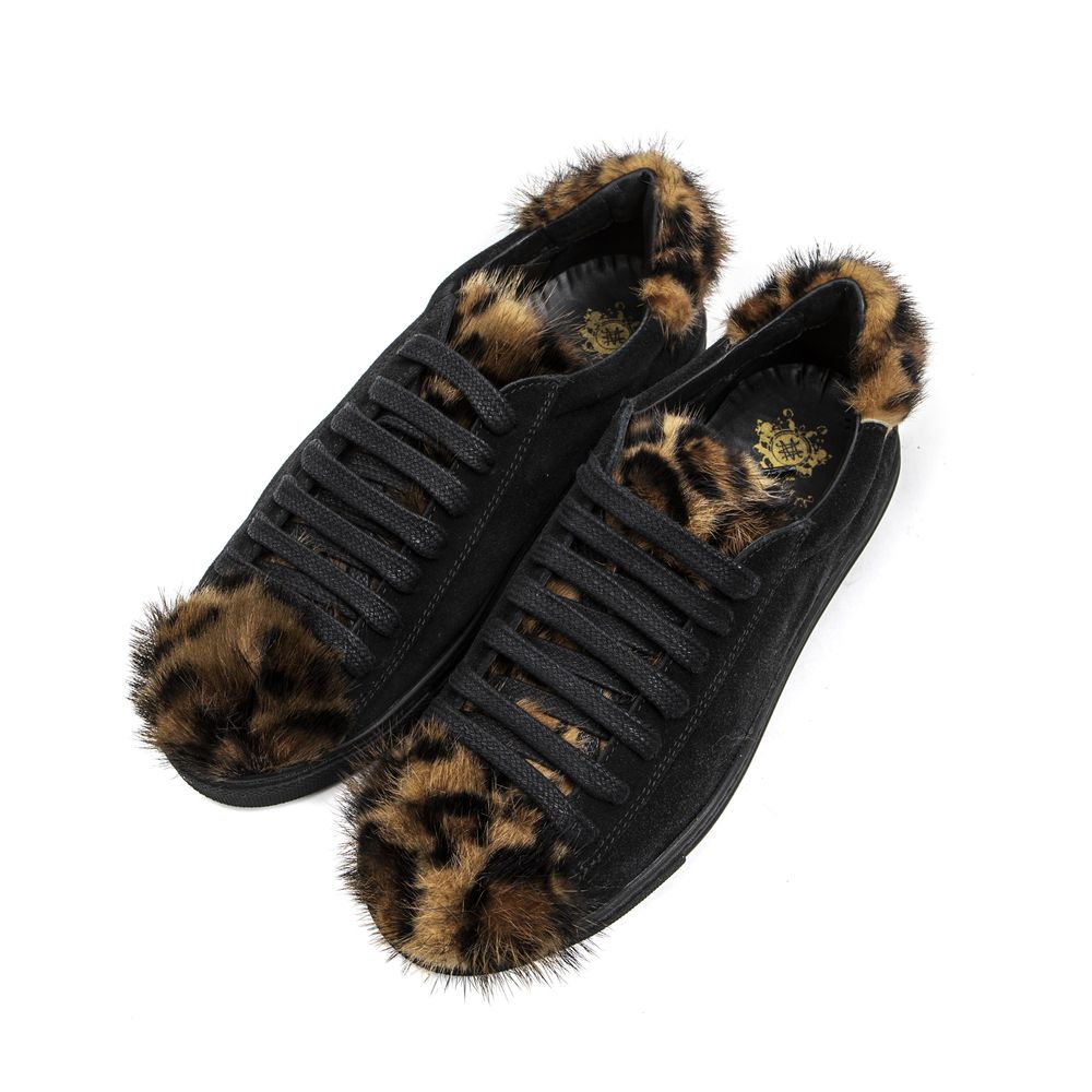 A pair of black leather women's sneakers with fur trim on the bottom and a textured sole