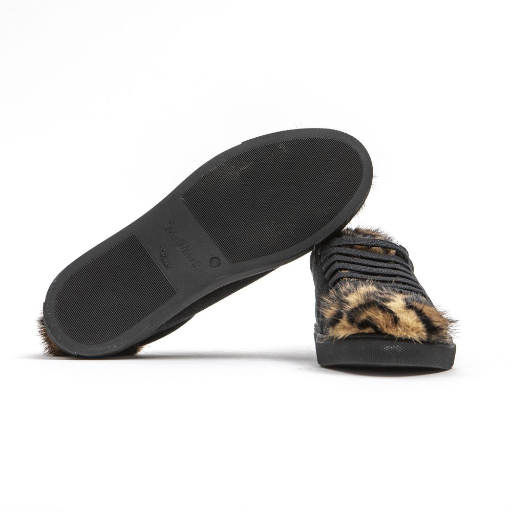 A black leather women's sneaker with a furry trim on the sole