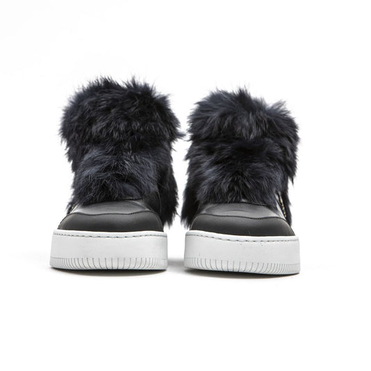 Pair of blue furry slip-on shoes with white soles