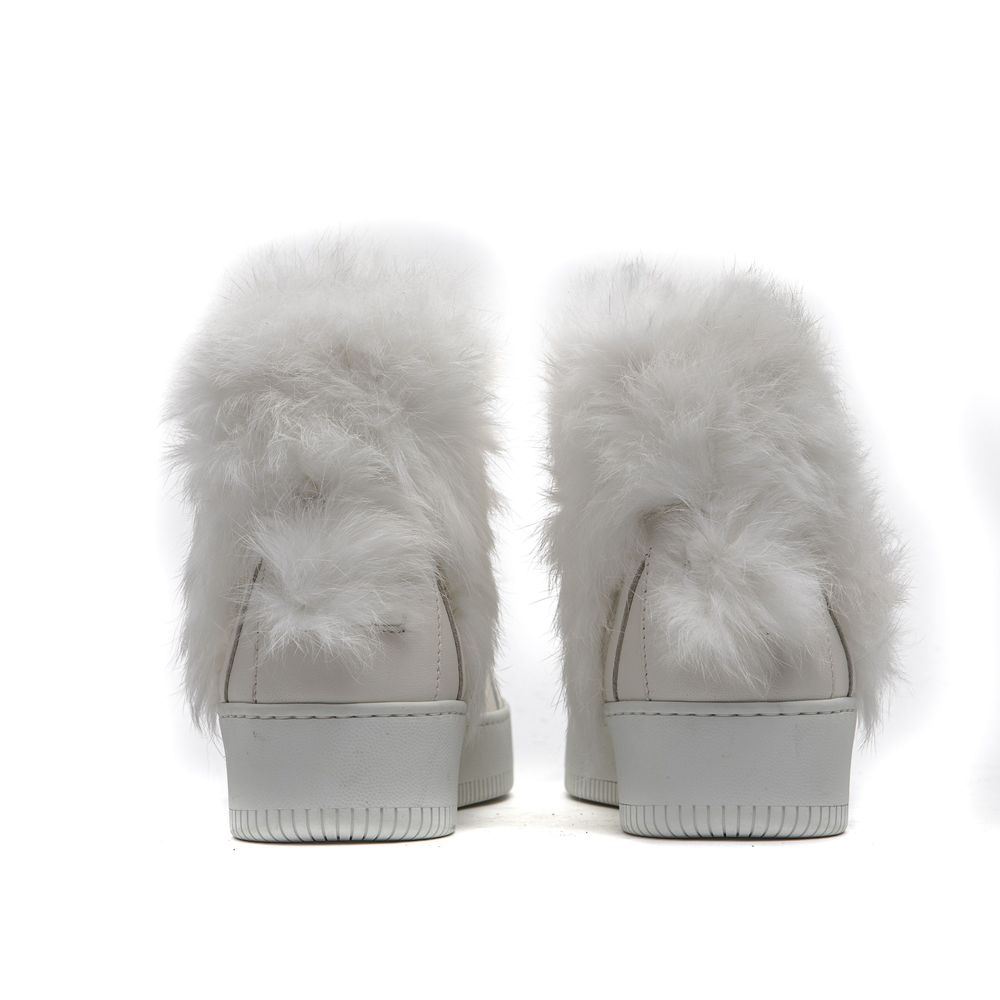 Pair of white furry slip-on shoes with a cotton base and a low heel