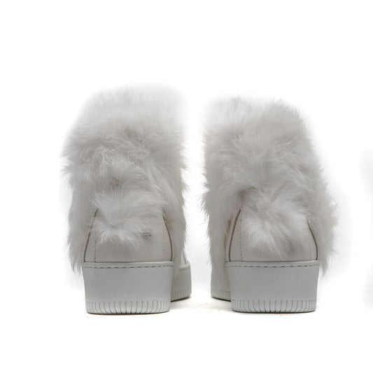 Pair of white furry slip-on shoes with a cotton base and a low heel