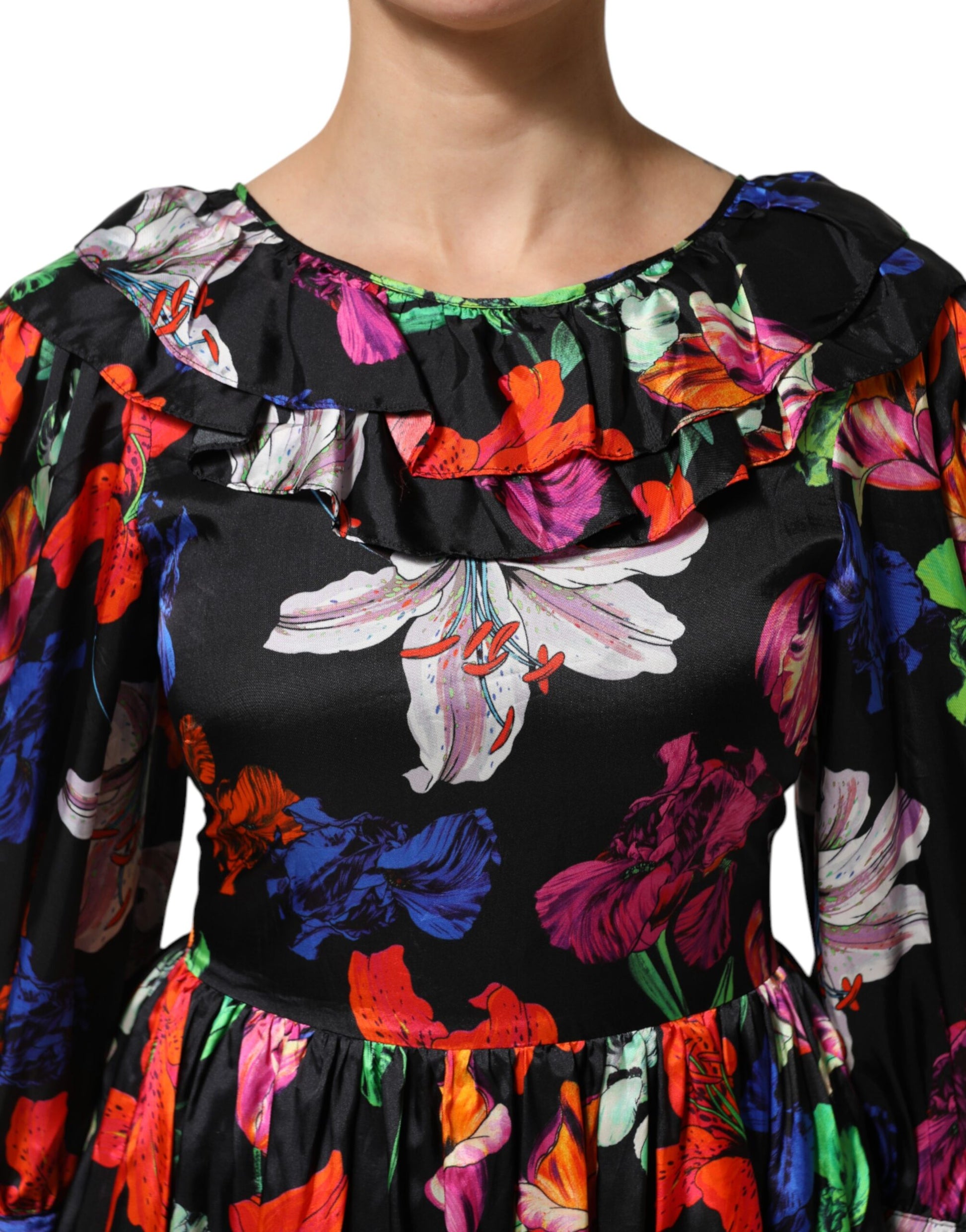 A black dress with a floral pattern and ruffles on the sleeves