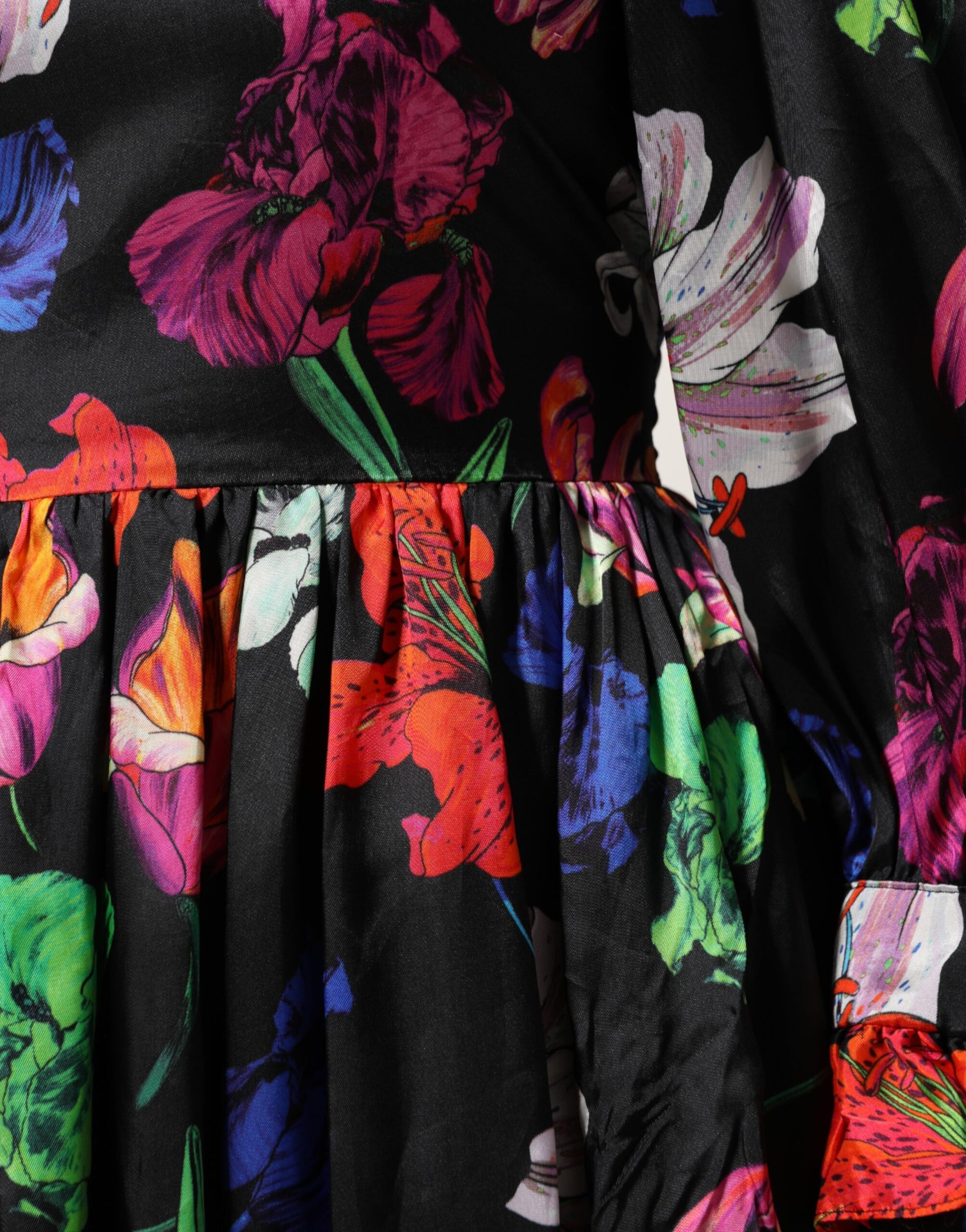A black dress with a floral pattern and ruffled sleeves