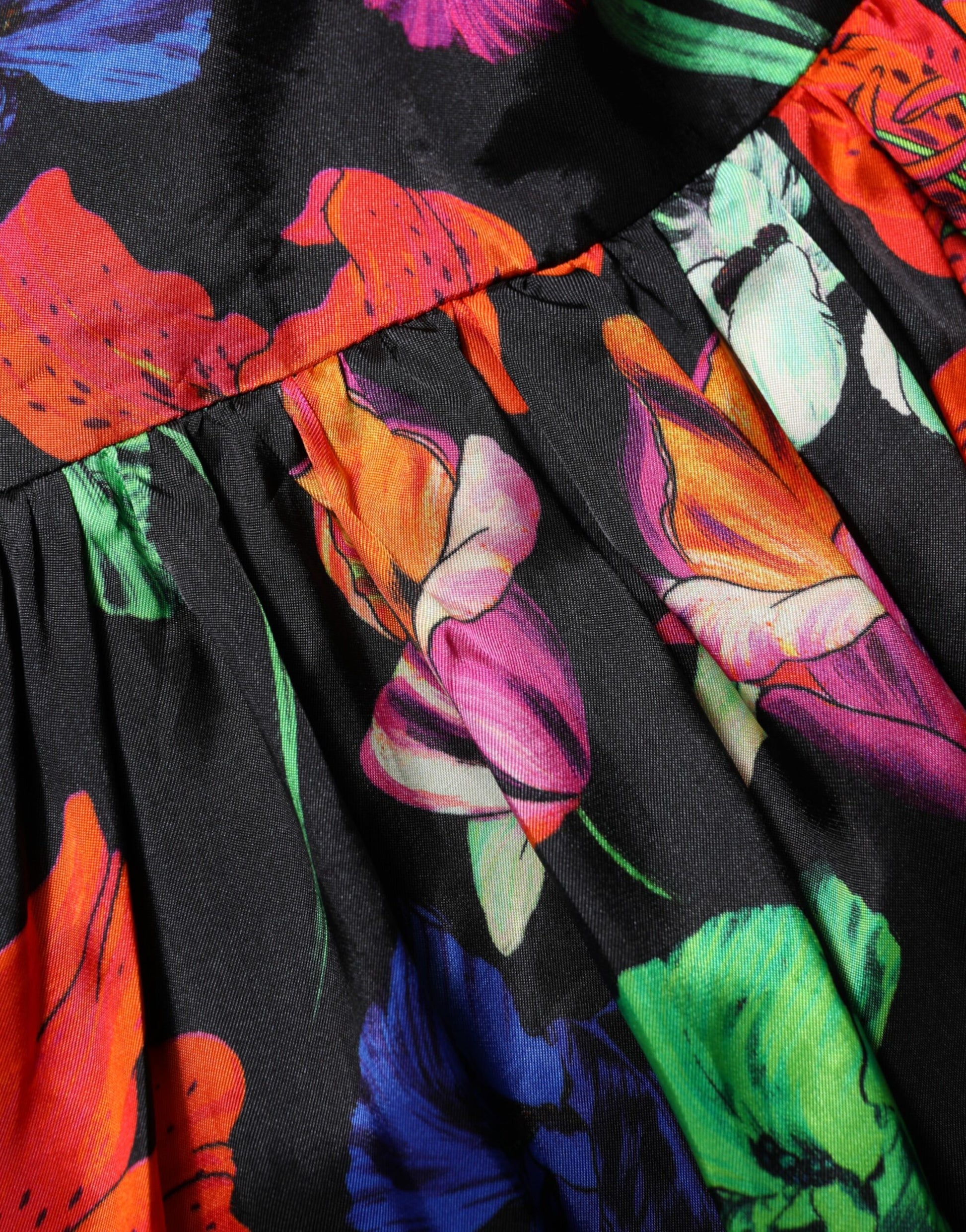A black dress with a floral pattern and ruffled sleeves