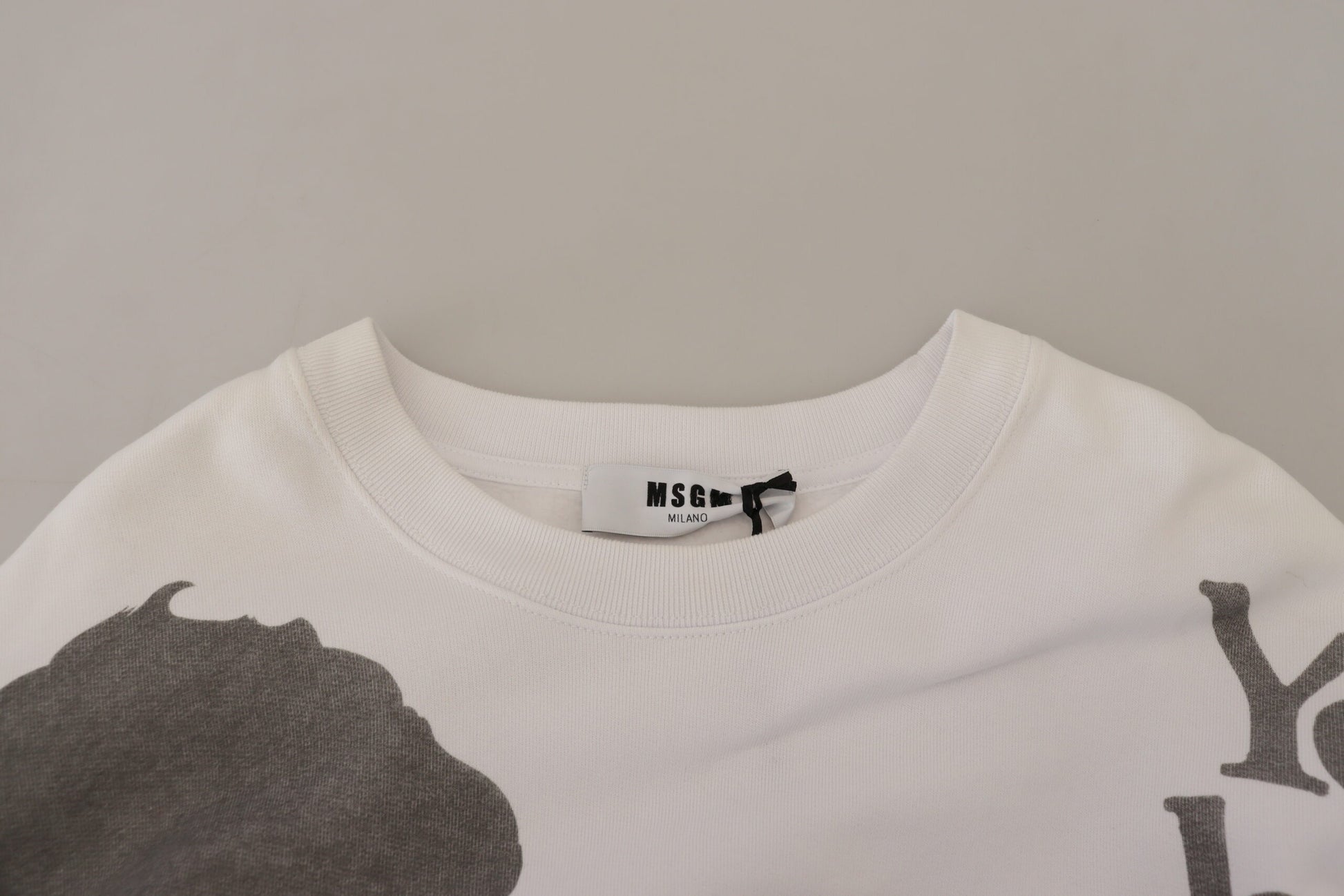 White sweater on hanger