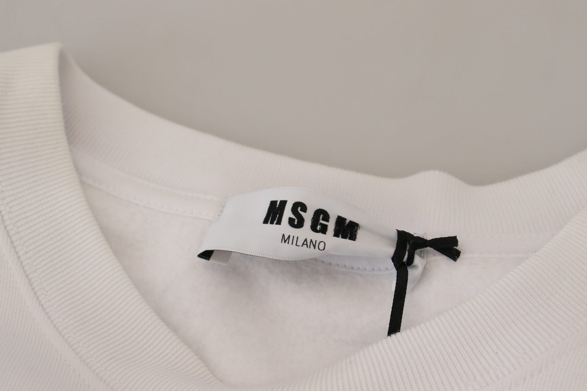 White t-shirt on hanger with tag