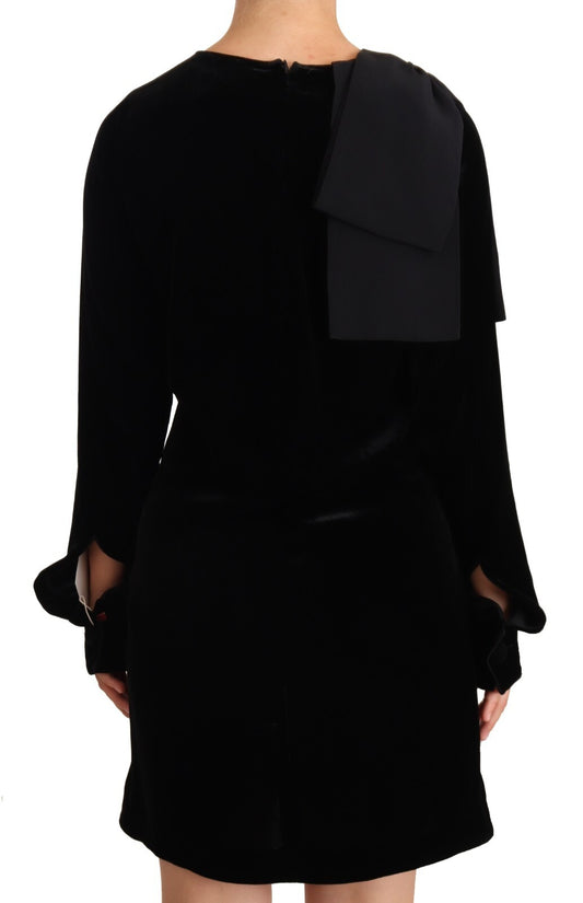A black viscose long sleeve dress with round neck and mini length