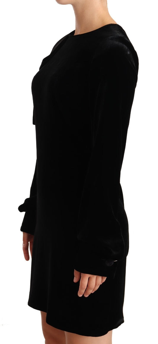 A black sheath dress with long sleeves and a round neckline, made of viscose fabric. It is designed to be a m