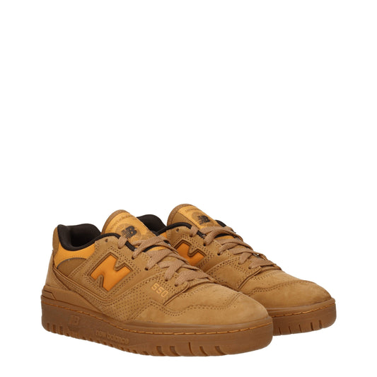Pair of brown leather sneakers with white laces, featuring a logo on the side and a flat sole