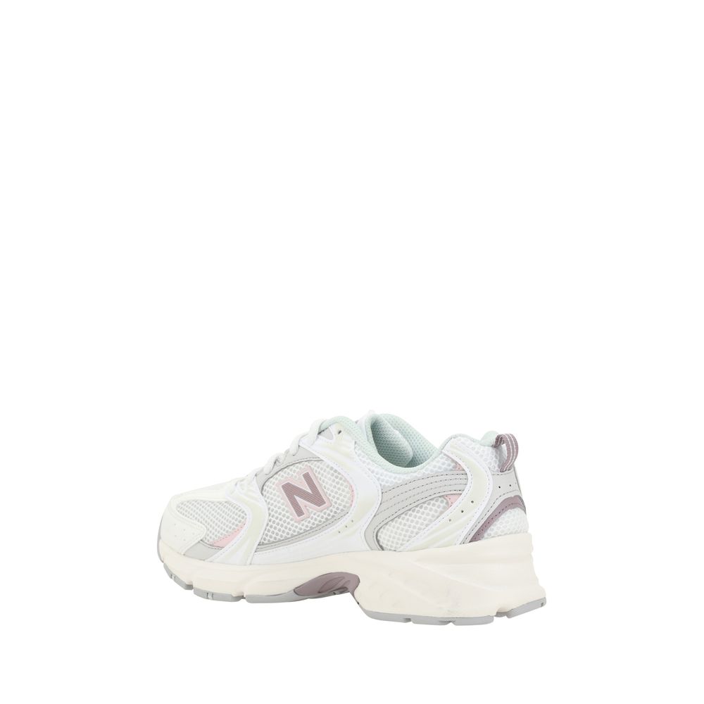 Pair of light pink sneakers with white soles