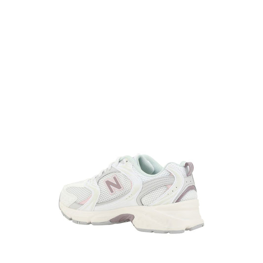 Pair of light pink sneakers with white soles