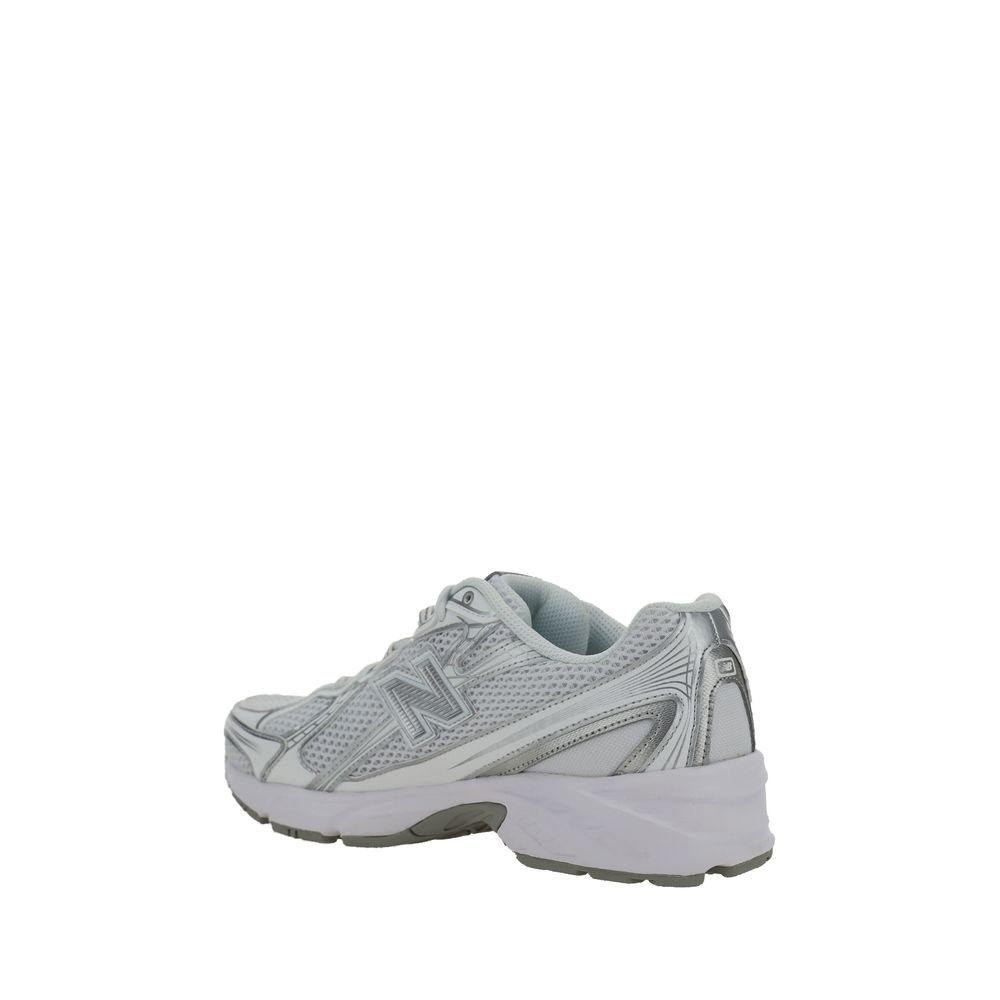 A pair of white athletic sneakers with a mesh upper, featuring a logo on the side and a rubber sole