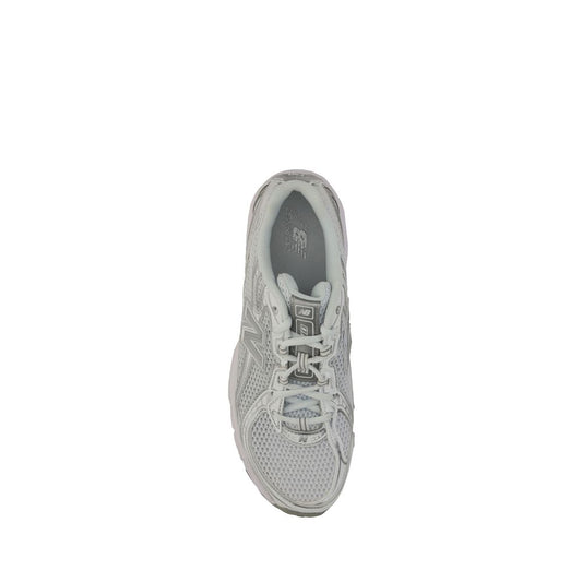 A single white athletic shoe with a pink logo on the side, featuring laces and a textured sole