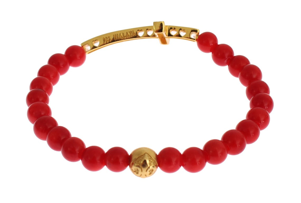 Gold bracelet with red beads and a gold ball charm