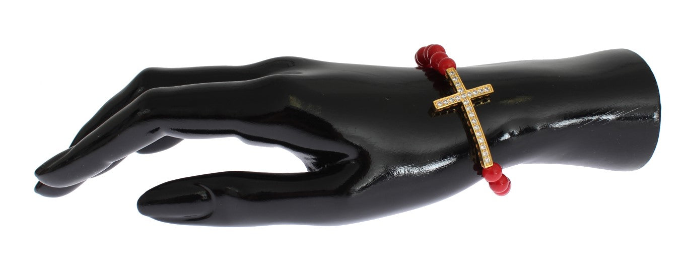 Black mannequin hand wearing a cross bracelet with red beads
